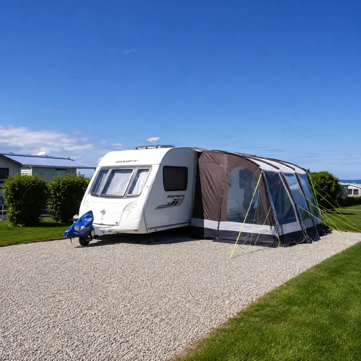 UK touring caravan connected to electric water and waste services