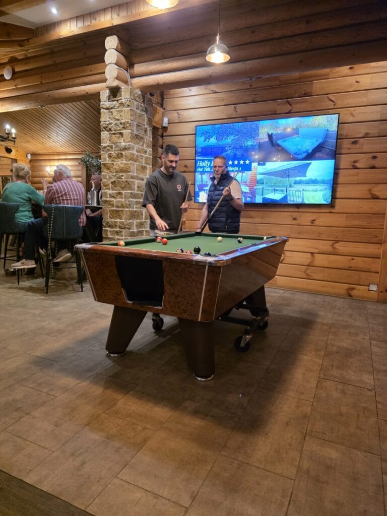 Playing pool in the Eye Kettleby Lakes clubhouse during our first visit to the site
